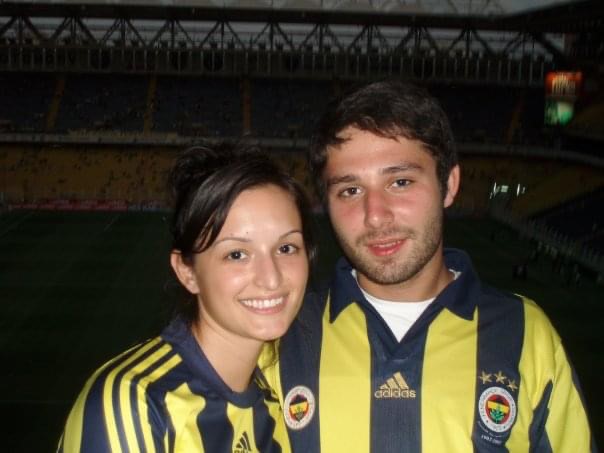 Woman and man with brown hair in Fenerbahce soccer jerseys